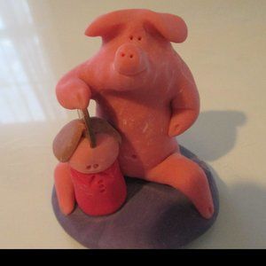 Pig Figurine placing a Penney Into His "People Bank"